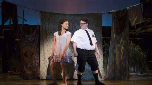 Kim Exum as Nabulungi and Cody Jamison Strand as Elder Cunningham in The Book of Mormon. © Julieta Cervantes
