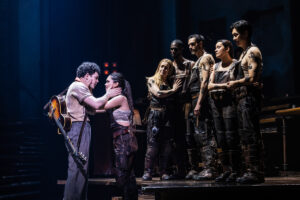 Ali Louis Bourzgui as Orpheus, Myra Molloy as Eurydice and the cast of Hadestown.
© Matthew Murphy