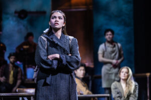 Myra Molloy as Eurydice and the cast of Hadestown.
© Matthew Murphy