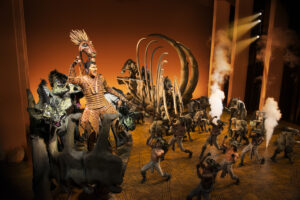 Stephen Carlile as Scar and the cast of The Lion King.